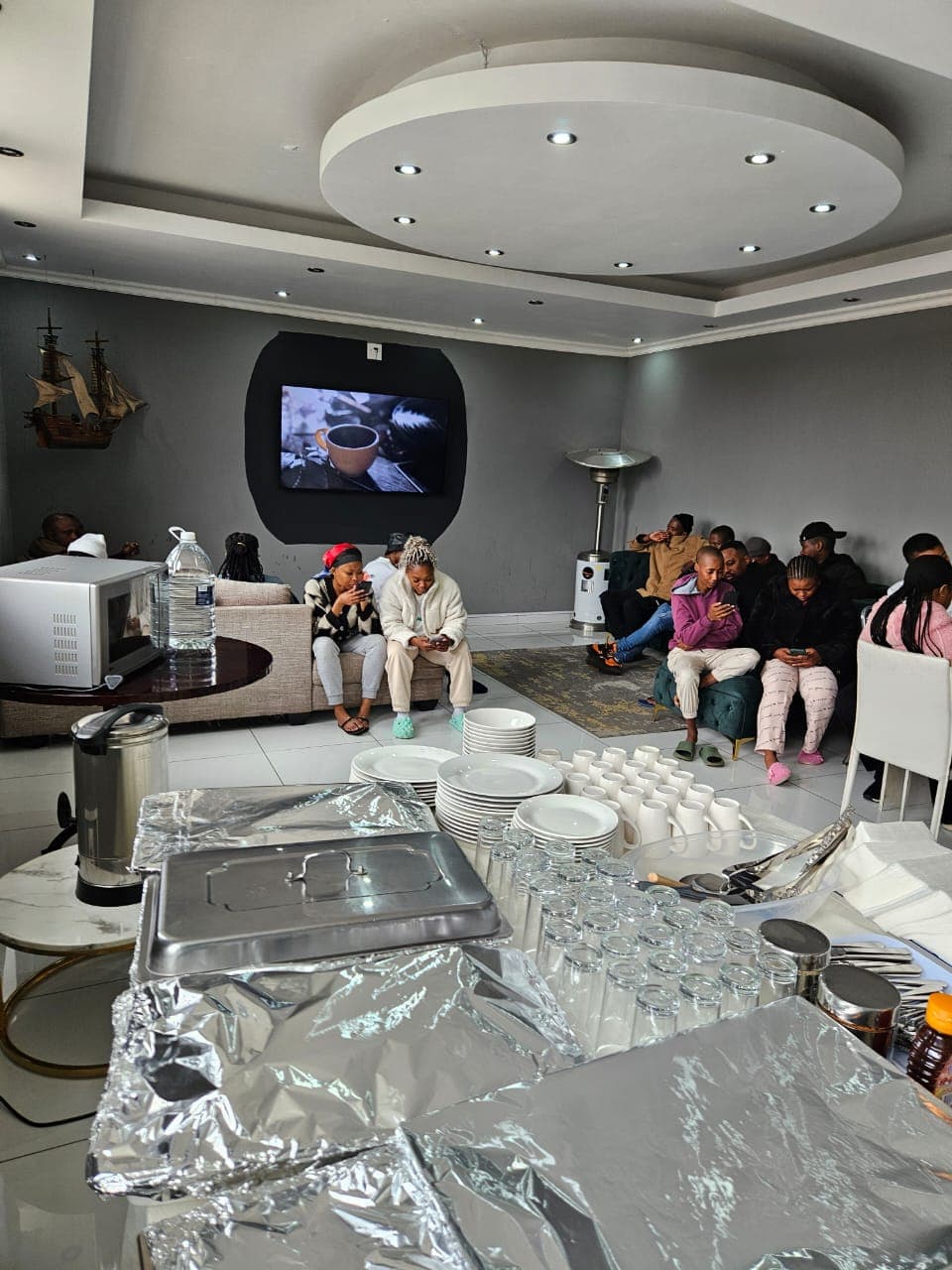 Guest TV lounge with hot buffet station and comfortable seating