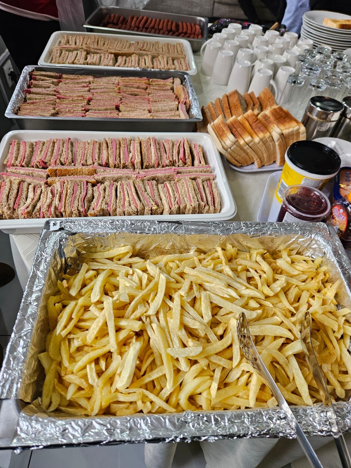 Fresh hotel catering spread with golden fries and sandwiches